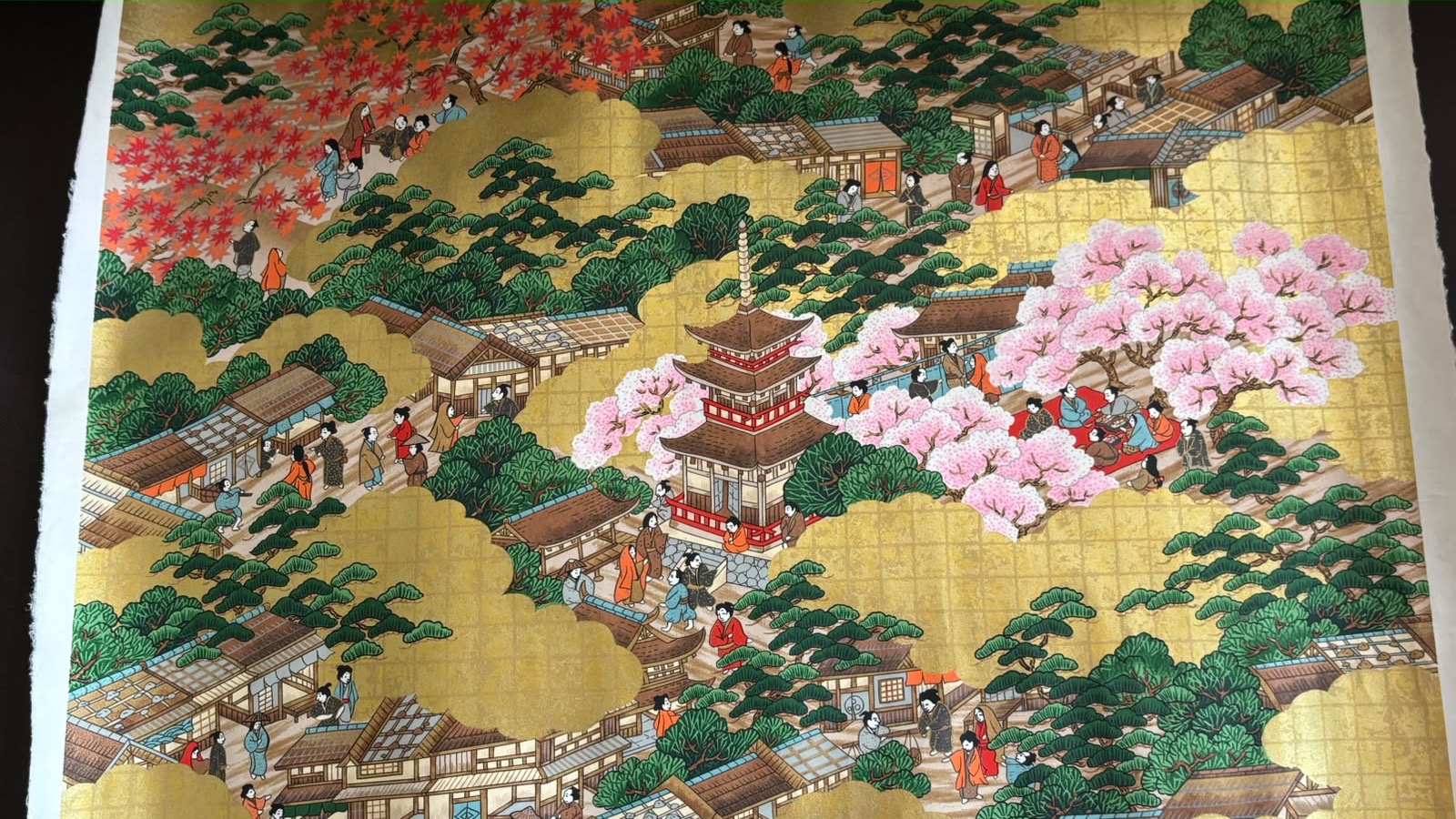 Gold-leaf painting of a pagoda and townspeople under cherry blossoms and autumn maples, Tokyo, Japan, photo 1 of 2