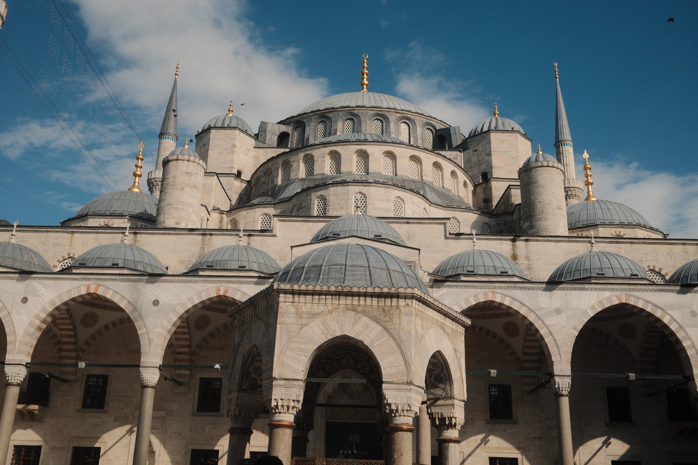 The Blue Mosque's domes and minarets against a clear sky.